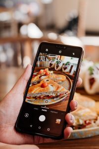 Food blogger taking a picture of a dish at a restaurant