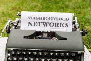typewriter with a "neighborhood networks" written on it 