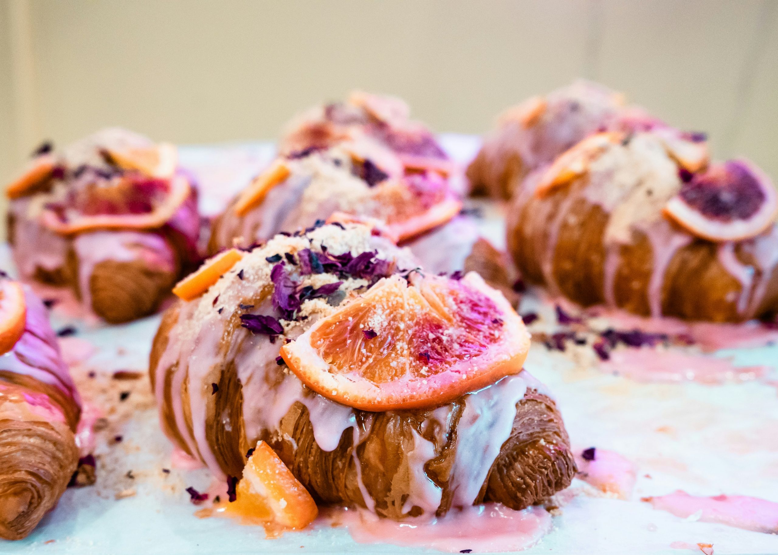 Croissants with pink garnish and fruit on top